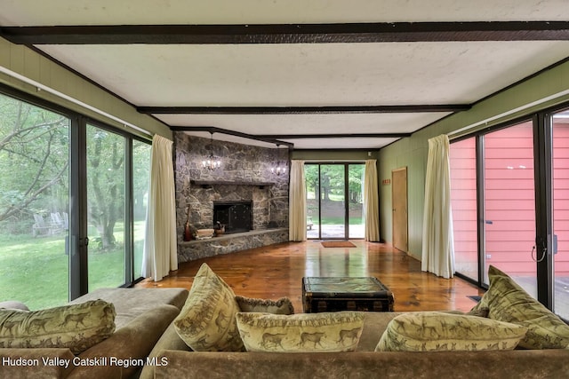 18 Maplewood Ave, Windham, NY 12496 - living room featuring wood finished floors, beamed ceiling, and a stone fireplace