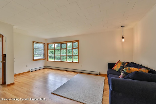 18 Maplewood Ave, Windham, NY 12496 - living area with wood finished floors and a baseboard radiator