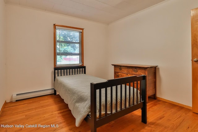 18 Maplewood Ave, Windham, NY 12496 - bedroom with a baseboard heating unit, wood finished floors, and ornamental molding