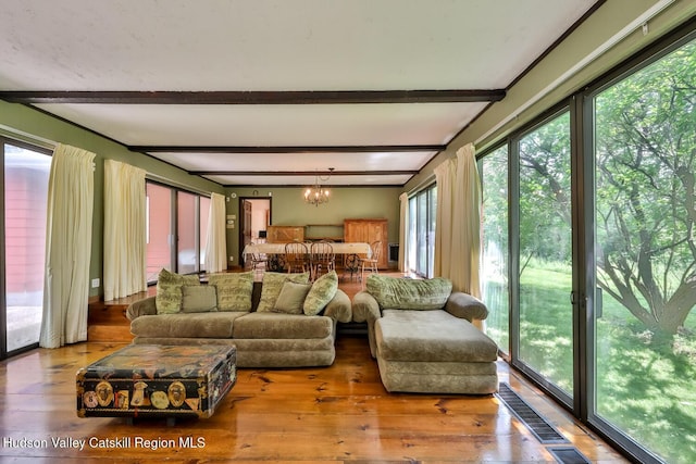 18 Maplewood Ave, Windham, NY 12496 - living area featuring a chandelier, beamed ceiling, plenty of natural light, and hardwood / wood-style floors