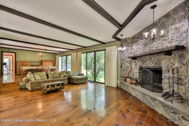 18 Maplewood Ave, Windham, NY 12496 - living room with a chandelier, beam ceiling, hardwood / wood-style floors, and a fireplace