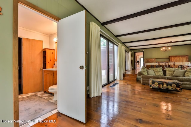 18 Maplewood Ave, Windham, NY 12496 - living room featuring a chandelier, beam ceiling, and hardwood / wood-style flooring