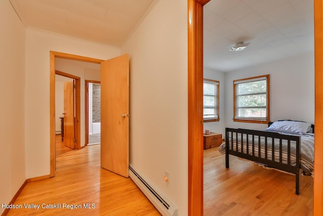 18 Maplewood Ave, Windham, NY 12496 - bedroom with a baseboard radiator, light wood-style floors, crown molding, and baseboard heating