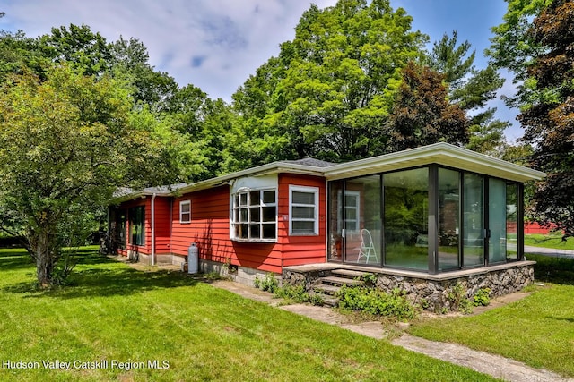 18 Maplewood Ave, Windham, NY 12496 - view of side of home with a sunroom and a lawn