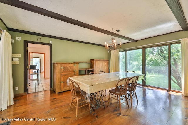 18 Maplewood Ave, Windham, NY 12496 - dining room with beam ceiling, wood-type flooring, a chandelier, and crown molding