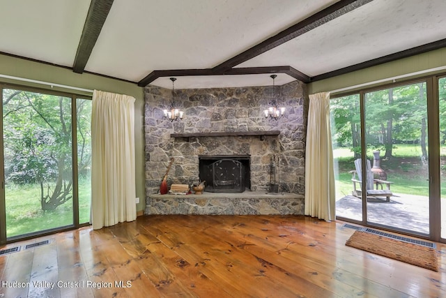 18 Maplewood Ave, Windham, NY 12496 - unfurnished living room with beam ceiling, wood-type flooring, a fireplace, and a chandelier