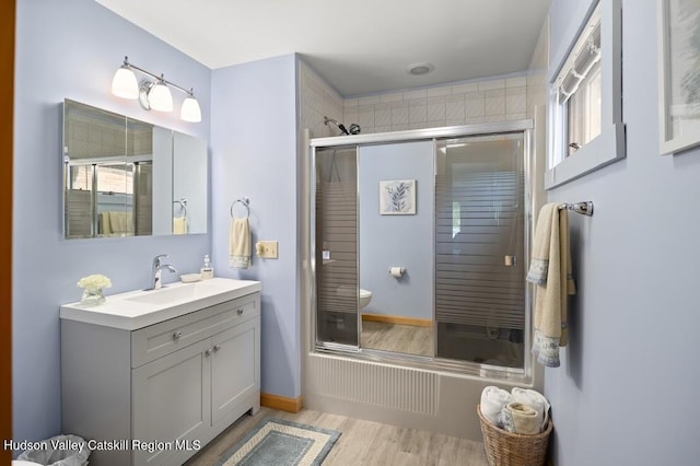 1024 Lakeview Rd, Copake, NY 12516 - bathroom featuring wood finished floors, vanity, and shower / bath combination with glass door
