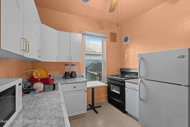 kitchen featuring white appliances, white cabinetry, ceiling fan, and sink