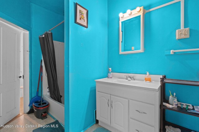 bathroom featuring vanity and shower / bath combo with shower curtain