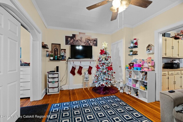 interior space with hardwood / wood-style floors, ceiling fan, and crown molding