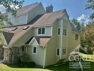 274 Brooksburgh Rd Unit 41, Windham, NY 12496 - back of house with a chimney and a lawn