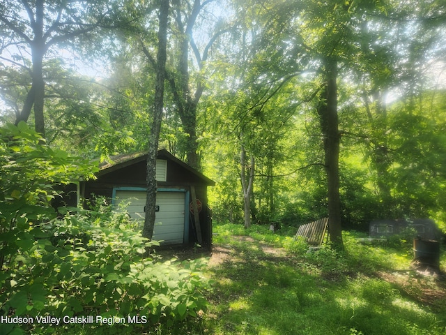 536 N Riverside Rd Rd, Lloyd, NY 12528 - view of yard with a detached garage and a wooded view