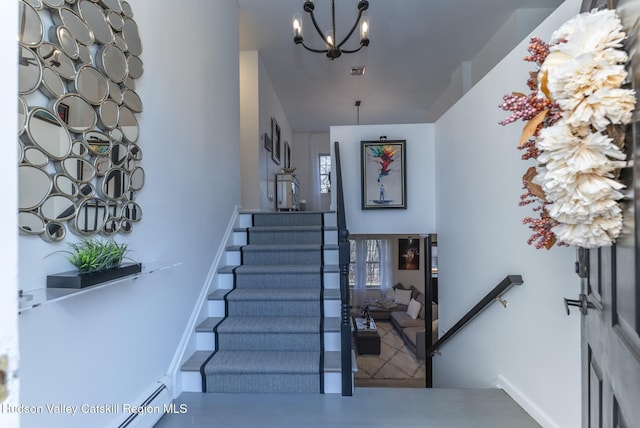 entrance foyer featuring an inviting chandelier and baseboard heating