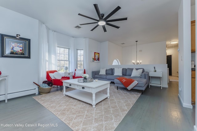 living room with wood-type flooring, ceiling fan with notable chandelier, and a baseboard heating unit