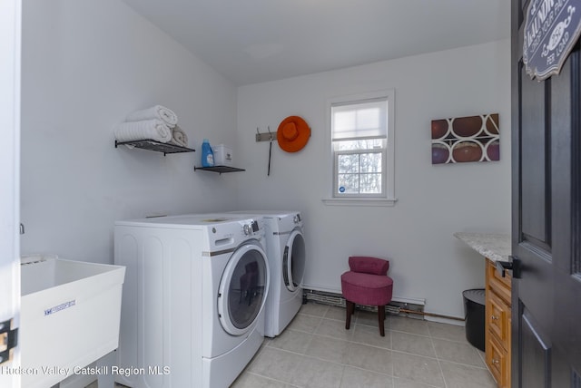 washroom with light tile patterned flooring, separate washer and dryer, and sink