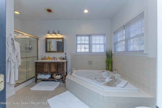 bathroom featuring tile patterned floors, separate shower and tub, and vanity