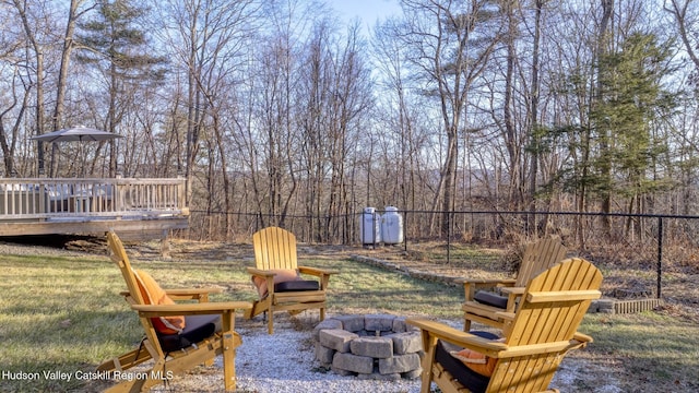 view of yard featuring a fire pit and a deck