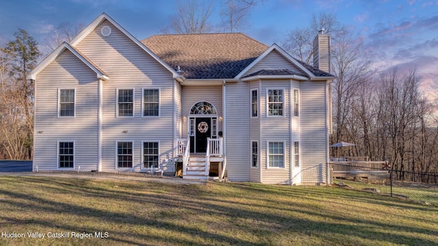 bi-level home featuring a lawn