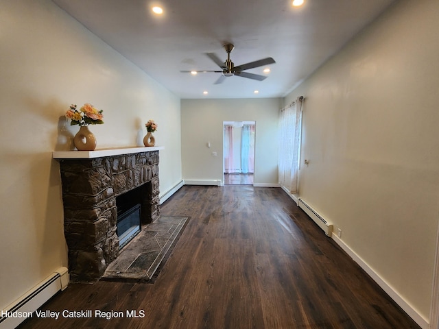 living room with dark wood-type flooring, ceiling fan, a fireplace, and a baseboard radiator