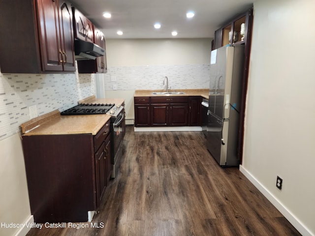 kitchen featuring decorative backsplash, appliances with stainless steel finishes, dark hardwood / wood-style floors, and sink