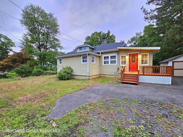 view of front of home featuring a front yard and a deck