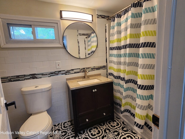 bathroom featuring tile patterned floors, tile walls, and a shower with shower curtain