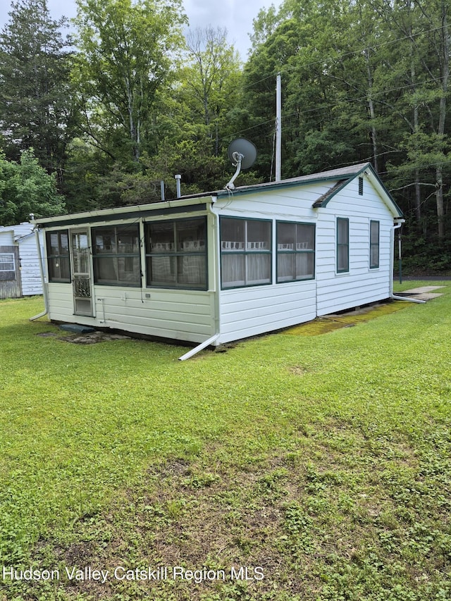 514 Upper Cherrytown Rd, Kerhonkson, NY 12446 - view of property exterior with a sunroom and a yard