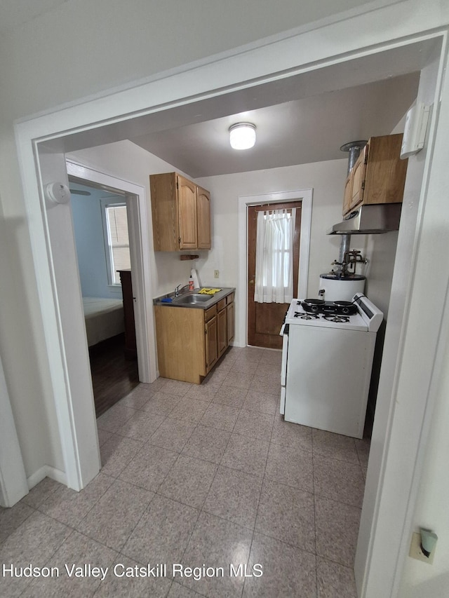 514 Upper Cherrytown Rd, Kerhonkson, NY 12446 - kitchen with white gas range oven, under cabinet range hood, and brown cabinets