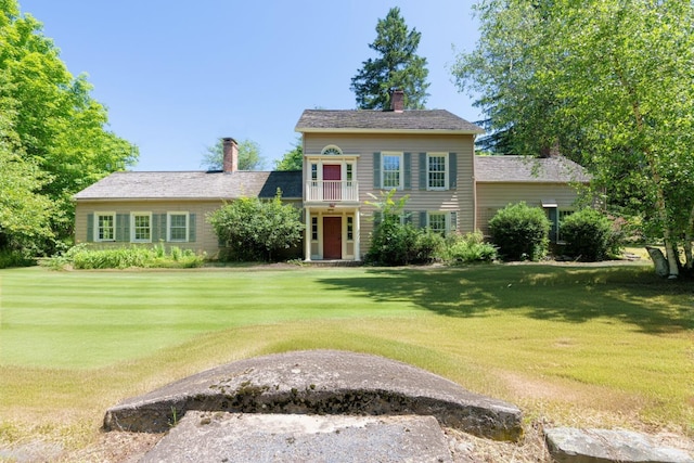 75 Allhusen Rd, Plattekill, NY 12561 - view of front of home with a front lawn, a chimney, and a balcony