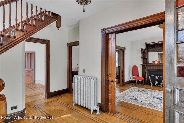 4930 State Route 81, Greenville, NY 12083 - hall featuring radiator, baseboards, parquet flooring, and stairway