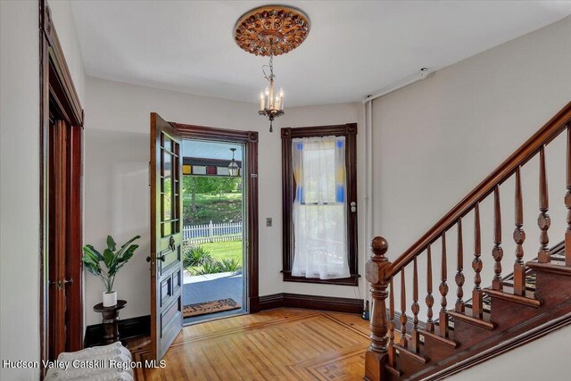 4930 State Route 81, Greenville, NY 12083 - foyer entrance featuring stairs, baseboards, wood finished floors, and a chandelier