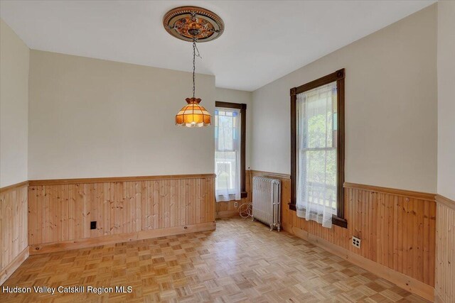 4930 State Route 81, Greenville, NY 12083 - unfurnished room featuring radiator heating unit, wainscoting, and wood walls