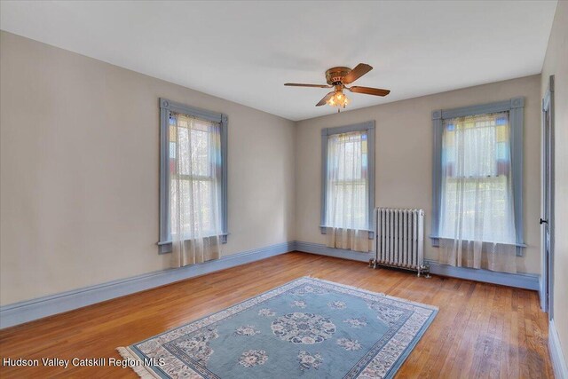 4930 State Route 81, Greenville, NY 12083 - empty room with radiator, ceiling fan, wood finished floors, and baseboards