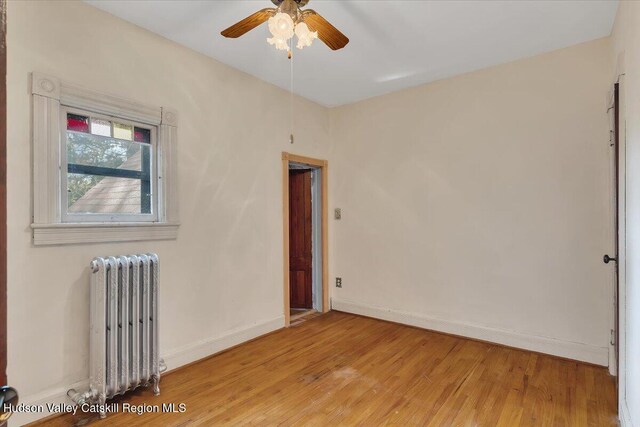 4930 State Route 81, Greenville, NY 12083 - unfurnished room featuring radiator heating unit, light wood-type flooring, a ceiling fan, and baseboards