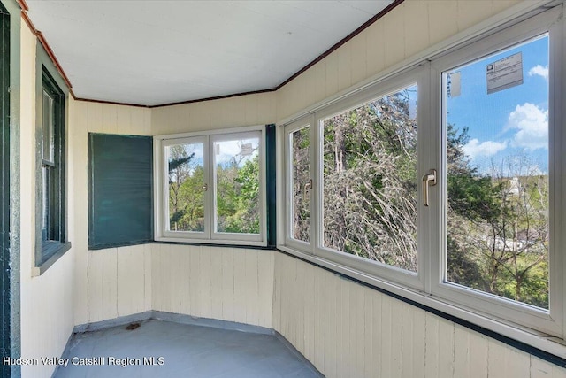 4930 State Route 81, Greenville, NY 12083 - unfurnished sunroom with wood walls, concrete floors, and crown molding
