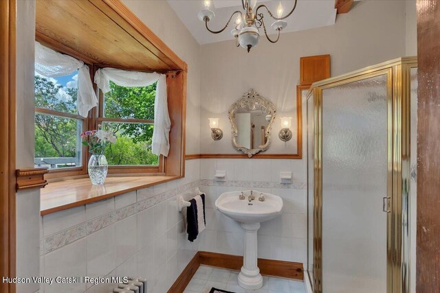 4930 State Route 81, Greenville, NY 12083 - full bath with a stall shower, a chandelier, tile walls, tile patterned flooring, and wainscoting