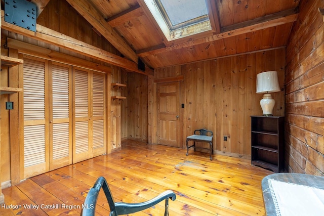 340 Lower Cady Rd, Old Chatham, NY 12136 - unfurnished room with wooden walls, a wood ceiling with exposed beams, a skylight, and hardwood / wood-style floors