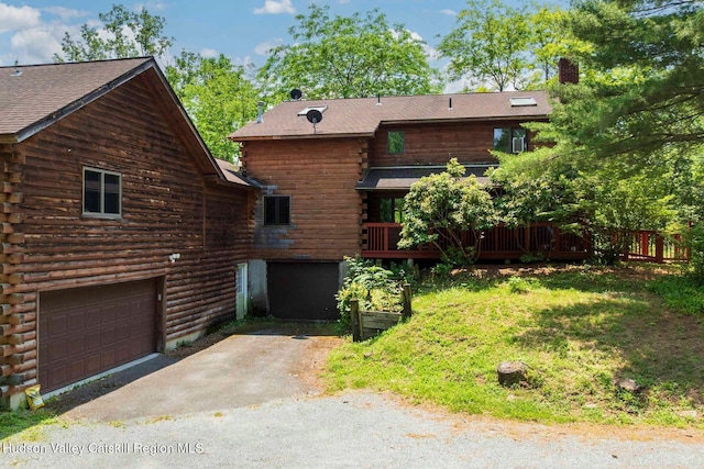 340 Lower Cady Rd, Old Chatham, NY 12136 - rear view of house featuring log exterior, an attached garage, asphalt driveway, a deck, and a chimney