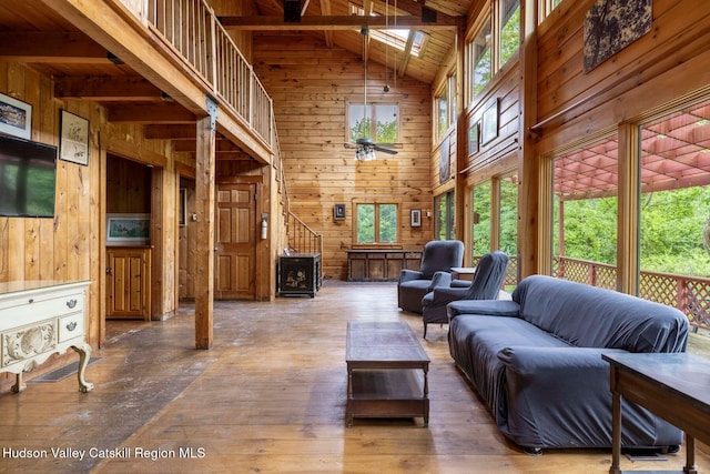 340 Lower Cady Rd, Old Chatham, NY 12136 - living area featuring wood walls, high vaulted ceiling, healthy amount of natural light, a wood ceiling with exposed beams, and hardwood / wood-style flooring