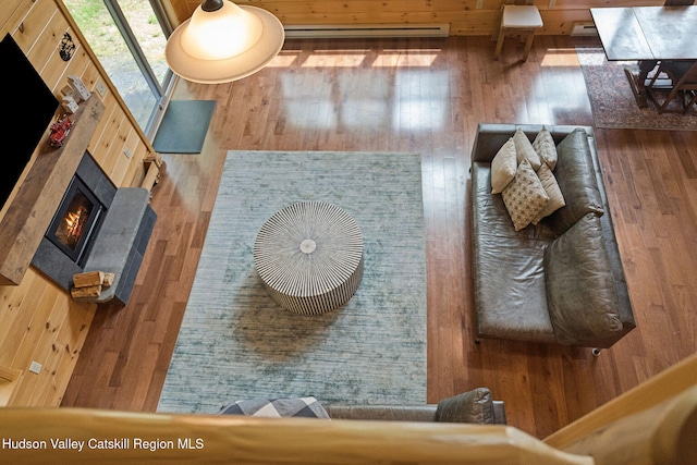 111 Ridgeway, Catskill, NY 12414 - living room featuring wood-type flooring, a tile fireplace, and wooden walls