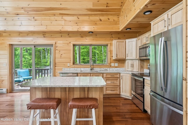 111 Ridgeway, Catskill, NY 12414 - kitchen featuring stainless steel appliances, wood ceiling, dark wood-style flooring, a sink, and a breakfast bar