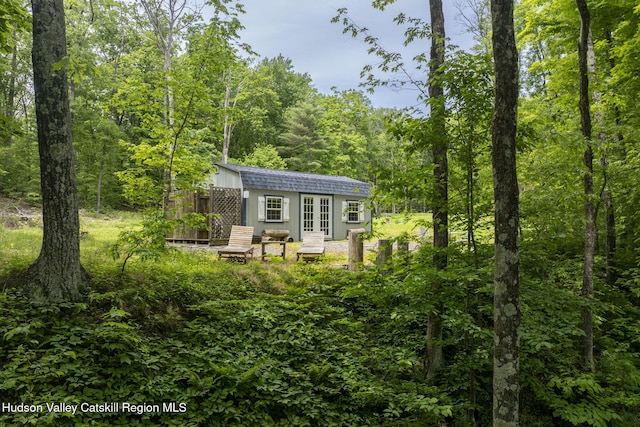 111 Ridgeway, Catskill, NY 12414 - back of property with french doors and a wooded view