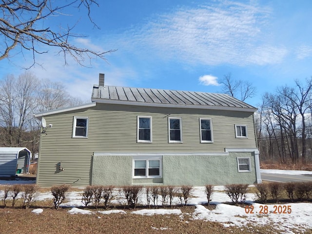 4700 Potter Hollow Rd, Preston Hollow, NY 12469 - view of snowy exterior featuring metal roof and stucco siding
