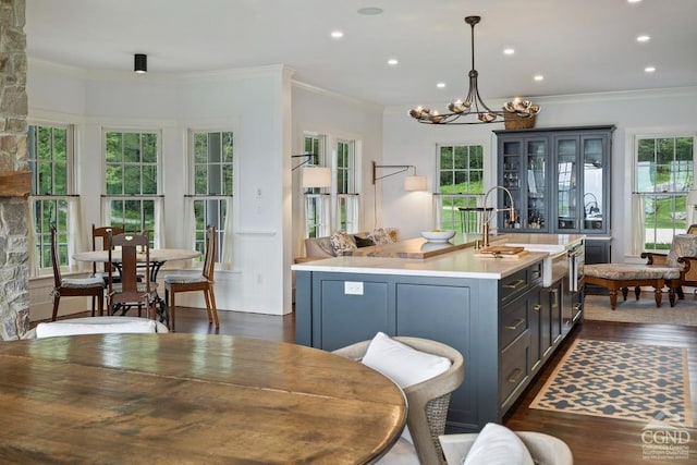470 Harrington Dr, Austerlitz, NY 12017 - kitchen with light countertops, a chandelier, dark wood-style floors, crown molding, and a kitchen island with sink