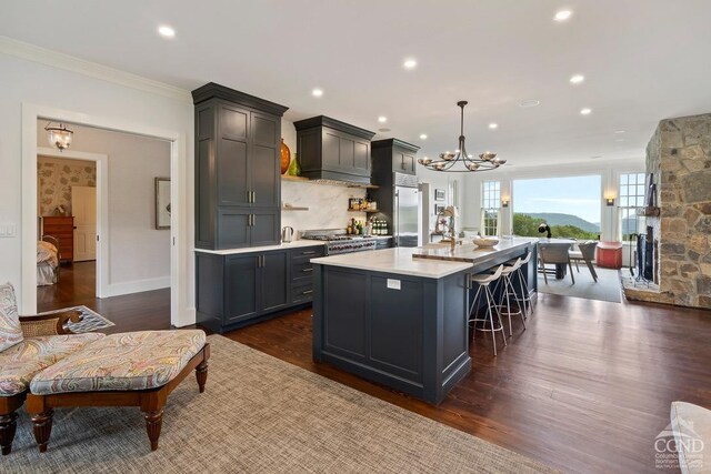 470 Harrington Dr, Austerlitz, NY 12017 - kitchen with light countertops, a spacious island, a chandelier, crown molding, and stainless steel built in refrigerator