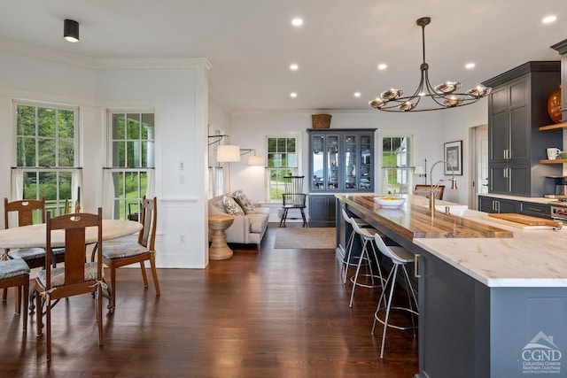 470 Harrington Dr, Austerlitz, NY 12017 - kitchen featuring ornamental molding, a chandelier, recessed lighting, light stone counters, and a breakfast bar