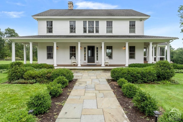 470 Harrington Dr, Austerlitz, NY 12017 - view of front of house with a chimney, a porch, and a front lawn