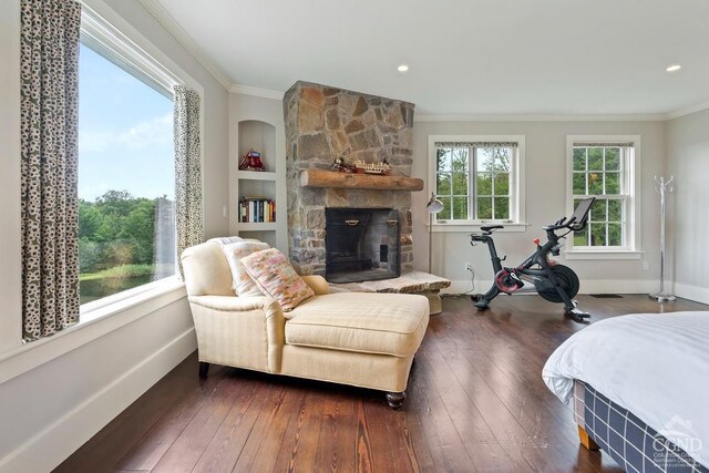470 Harrington Dr, Austerlitz, NY 12017 - bedroom featuring crown molding, dark wood-style flooring, a stone fireplace, and baseboards