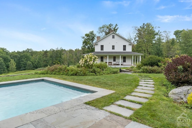 470 Harrington Dr, Austerlitz, NY 12017 - rear view of house featuring a porch, a chimney, a yard, and an outdoor pool