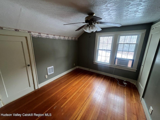 bonus room featuring cooling unit, vaulted ceiling, ceiling fan, a textured ceiling, and wood-type flooring